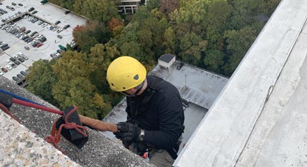 Worker Executing Vertical Jobs on a building and Safety Equipment