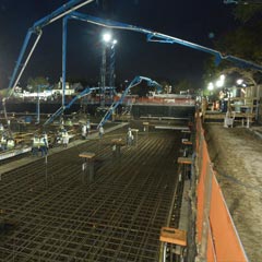 Cranes laying down foundation rebar