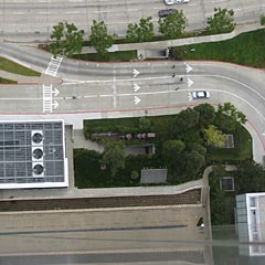 Aerial view of a building with HVAc system on top and roads around it